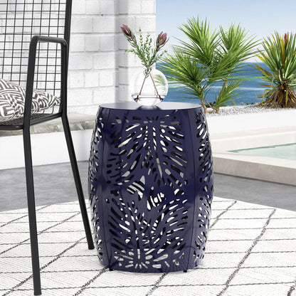 Blue palm-leaf cut-out metal outdoor end table with glass vase on a sunny patio scene on Tampa Home & Garden Store