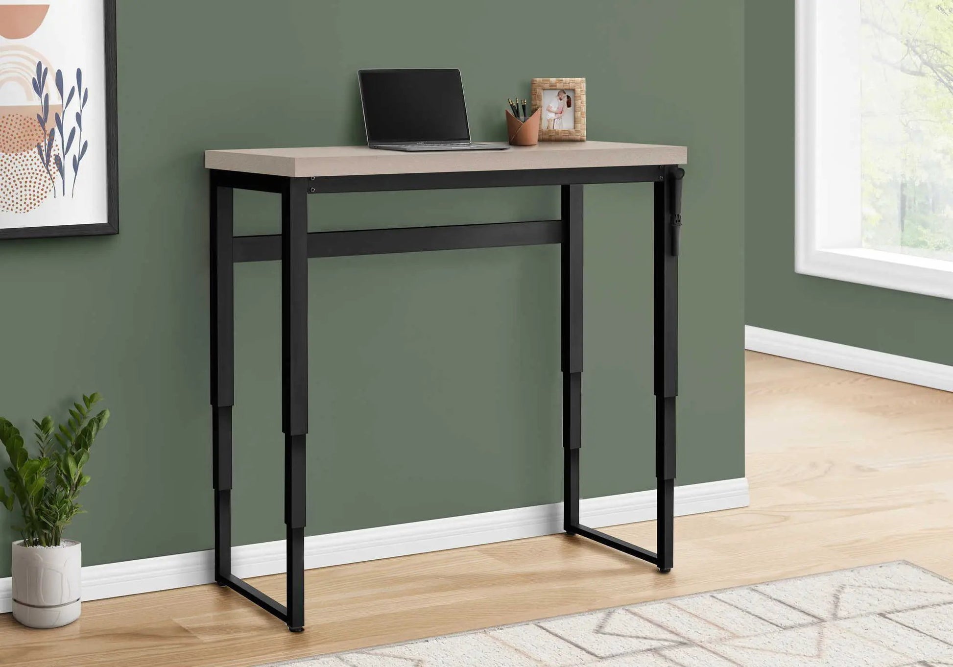 Computer desk standing adjustable with beige top and black metal frame, laptop on top on Tampa Home & Garden Store