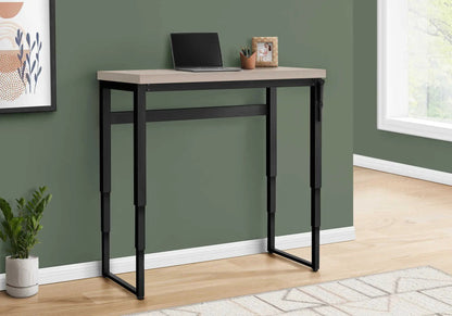 Computer desk standing adjustable with beige top and black metal frame, laptop on top on Tampa Home & Garden Store