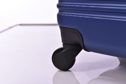 Luggage wheel close-up on blue hardside spinner suitcase on Tampa Home & Garden Store