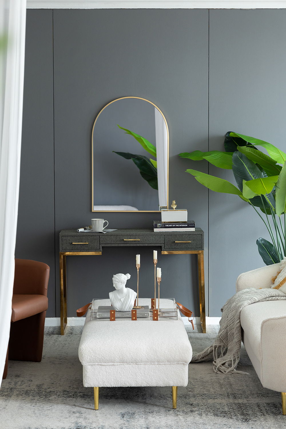 Arched wall mirror HouseOfZazla with gold frame above a dark console table in a living room on Tampa Home & Garden Store