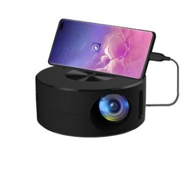 Smart portable 1080P LED projector in black with a phone resting on top and a front lens on Tampa Home & Garden Store