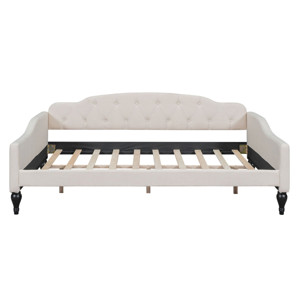 Upholstered tufted daybed in cream fabric with curved arms and button-tufted back, wooden legs on Tampa Home & Garden Store