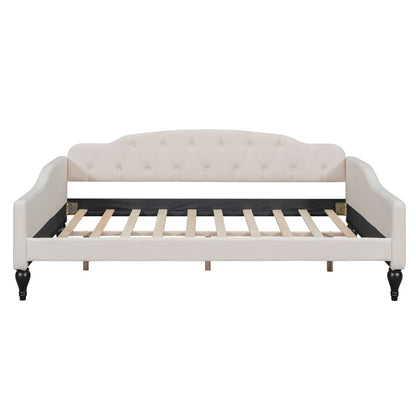 Upholstered tufted daybed in cream fabric with curved arms and button-tufted back, wooden legs on Tampa Home & Garden Store
