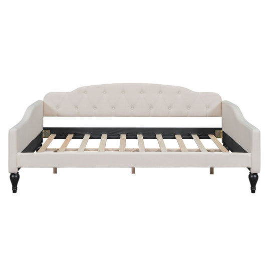 Upholstered tufted daybed in cream fabric with curved arms and button-tufted back, wooden legs on Tampa Home & Garden Store