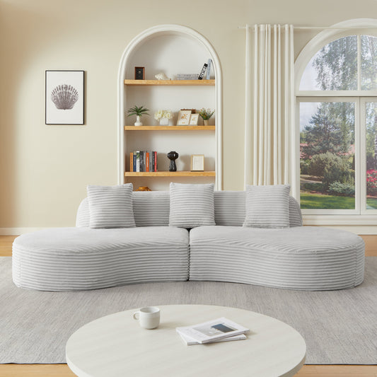 Contemporary corduroy curved sectional sofa in light gray with plush cushions in a living room on Tampa Home & Garden Store