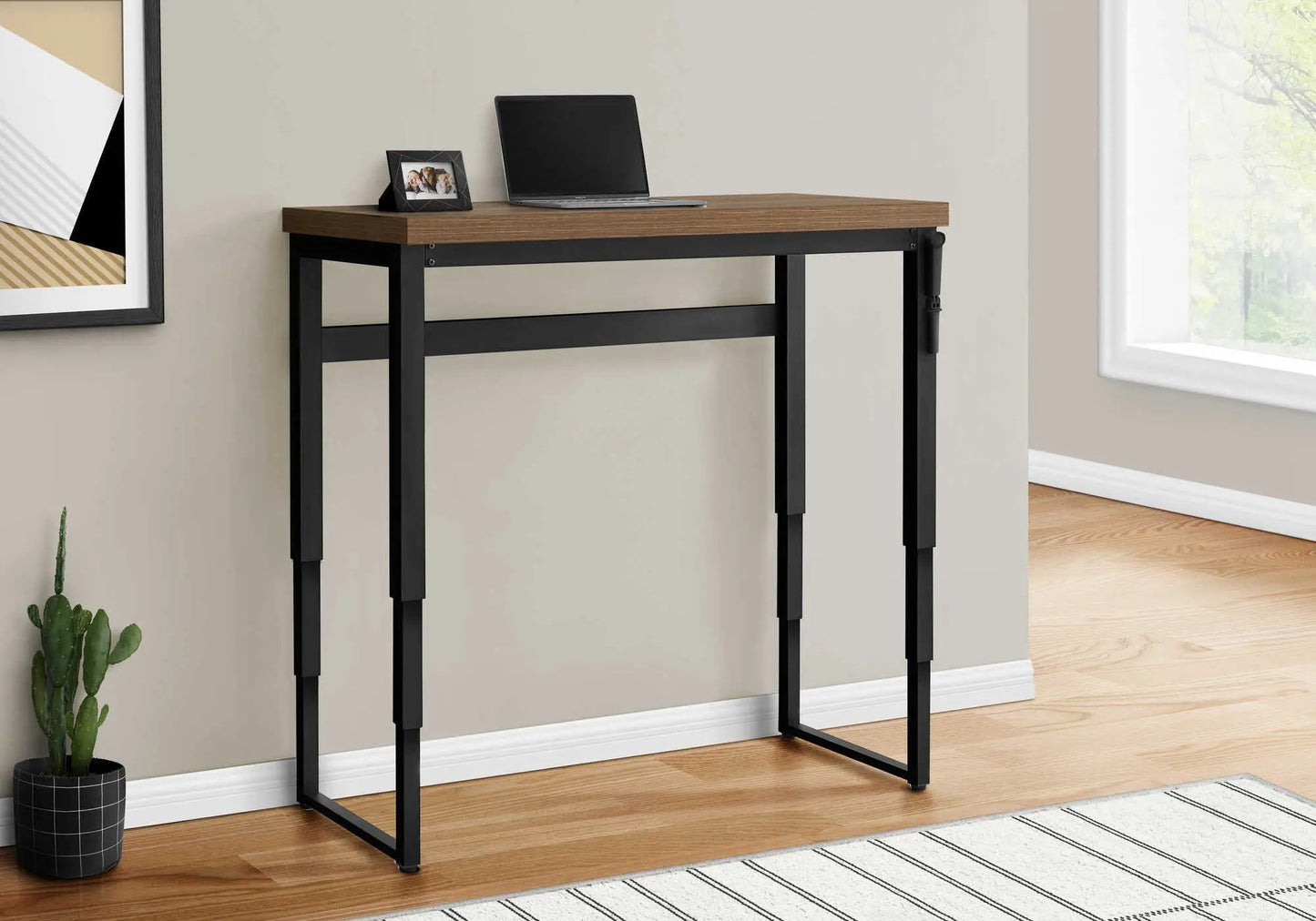 Standing adjustable computer desk with brown wood top and black metal frame, laptop on desk on Tampa Home & Garden Store