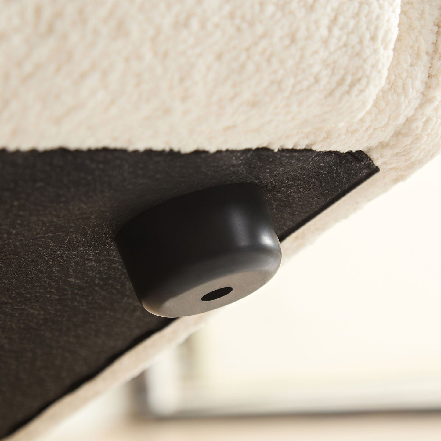 Sectional sofa close-up showing ivory plush fabric and black leather edge on Tampa Home & Garden Store