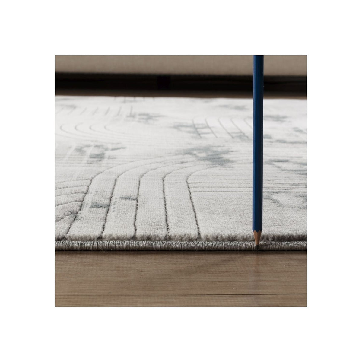 Ultra Soft Geometric Rug in Ivory and Gray close-up of rug edge with blue pencil for scale on Tampa Home & Garden Store