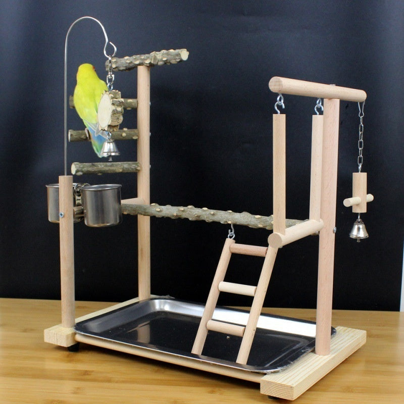 Parrot toy stand with natural wood branches, ladder and hanging bell accents on a base tray on Tampa Home & Garden Store