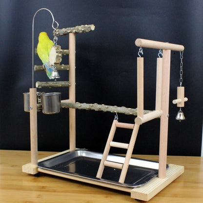 Parrot toy stand with natural wood branches, ladder and hanging bell accents on a base tray on Tampa Home & Garden Store