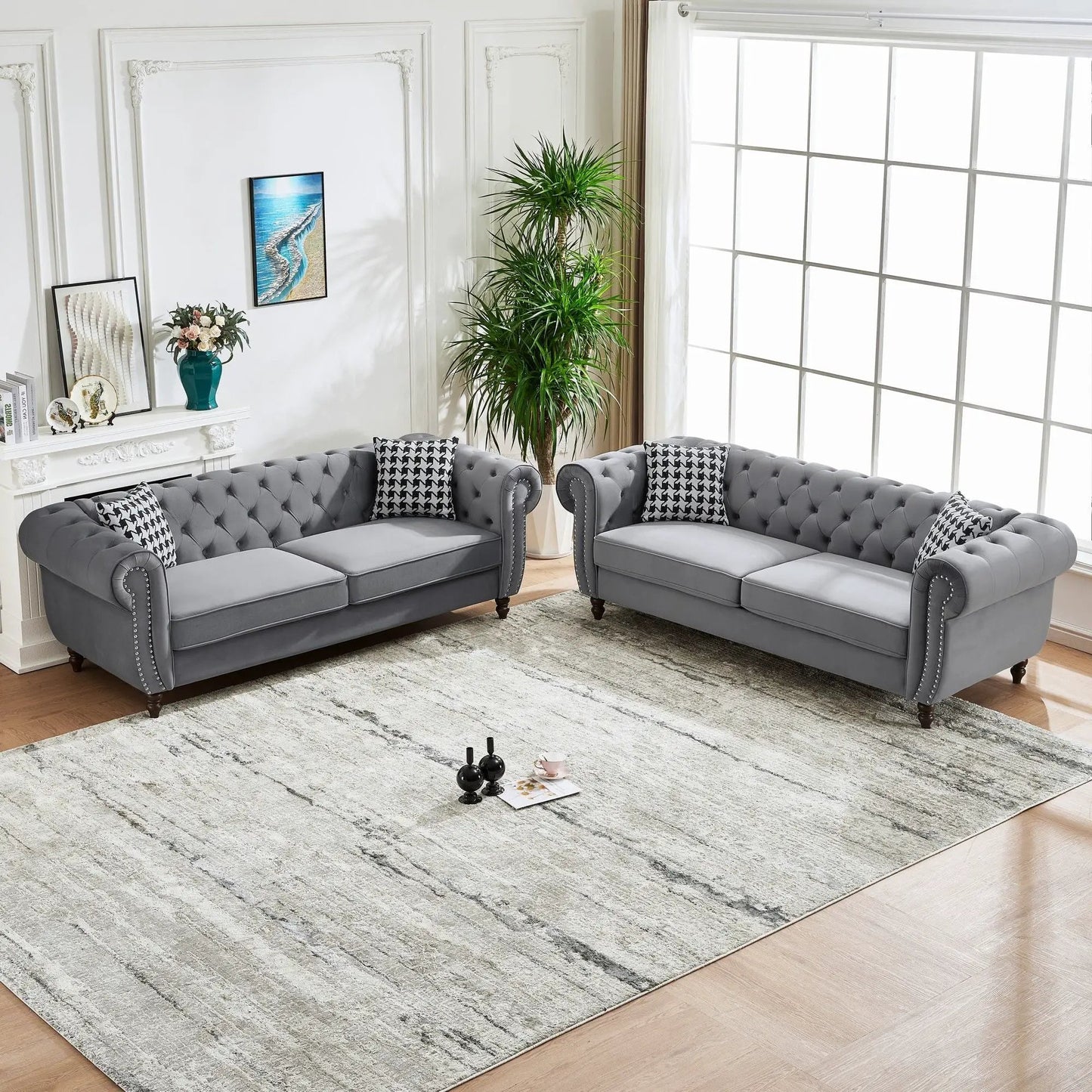 Two gray Chesterfield sofas with roll arms and nailhead trim by Unique Piece Furniture on Tampa Home & Garden Store