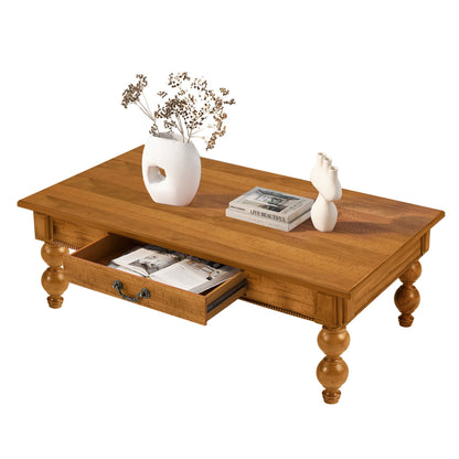Rectangular wooden coffee table with storage drawer in warm oak finish, vase with dried stems on Tampa Home & Garden Store