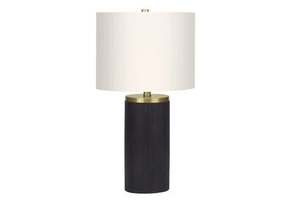 Table lamp with white fabric drum shade and black concrete-style base with brass accents on Tampa Home & Garden Store