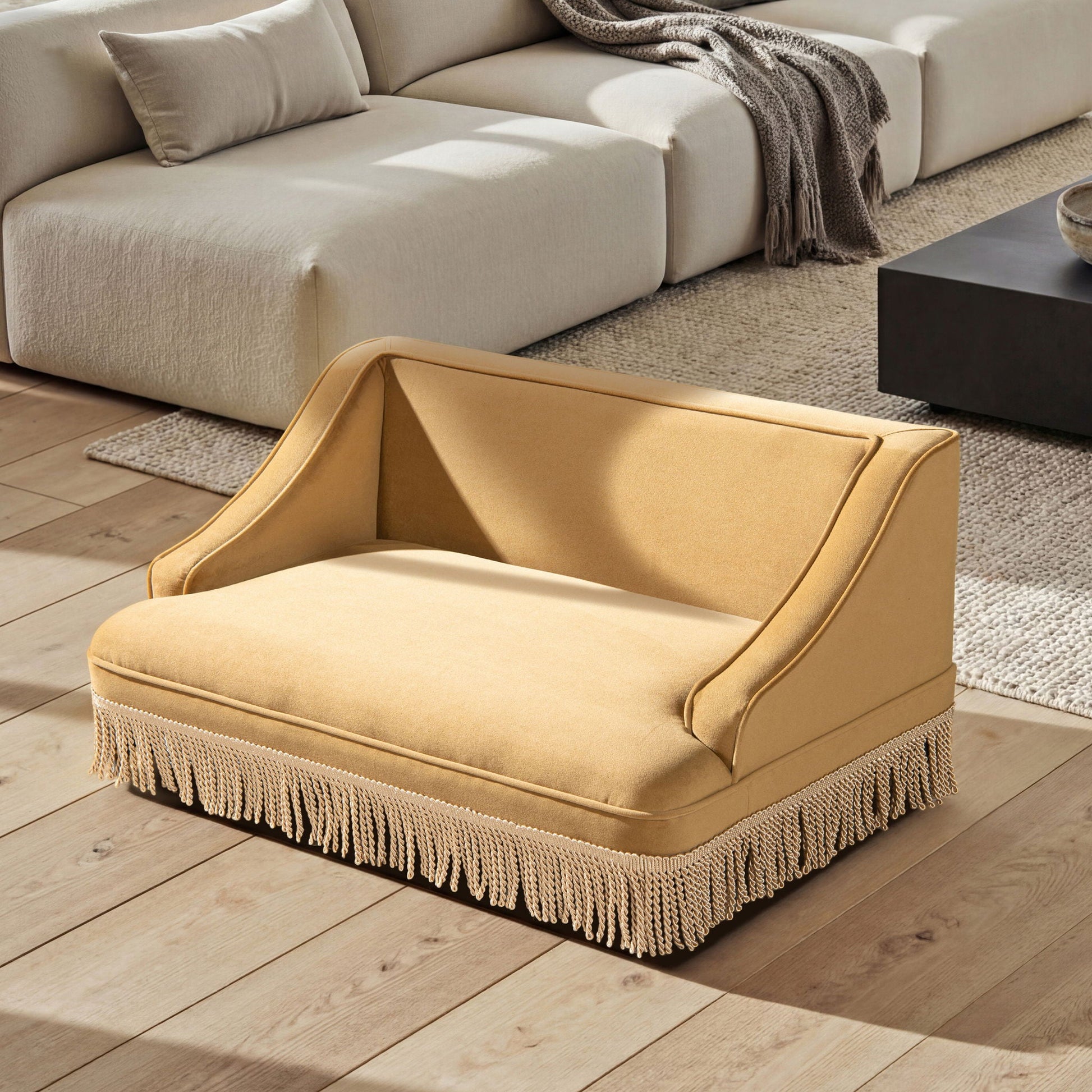 Duchess - Pet Bed Sofa beige fabric with fringe tassels on a living room floor on Tampa Home & Garden Store