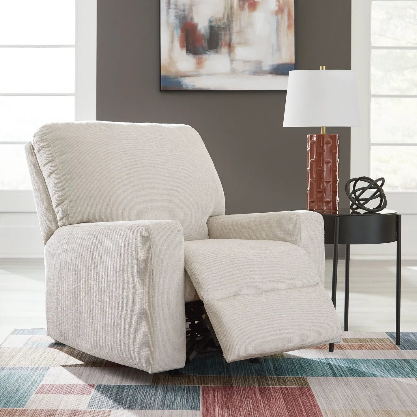 Aviemore Rocker Recliner beige fabric upholstery with exposed metal rocking mechanism on Tampa Home & Garden Store