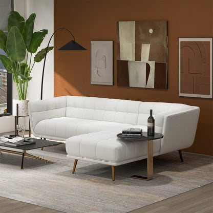 HouseOfZazla L-shaped tufted mid-century sofa in white with gold legs on brown wall on Tampa Home & Garden Store