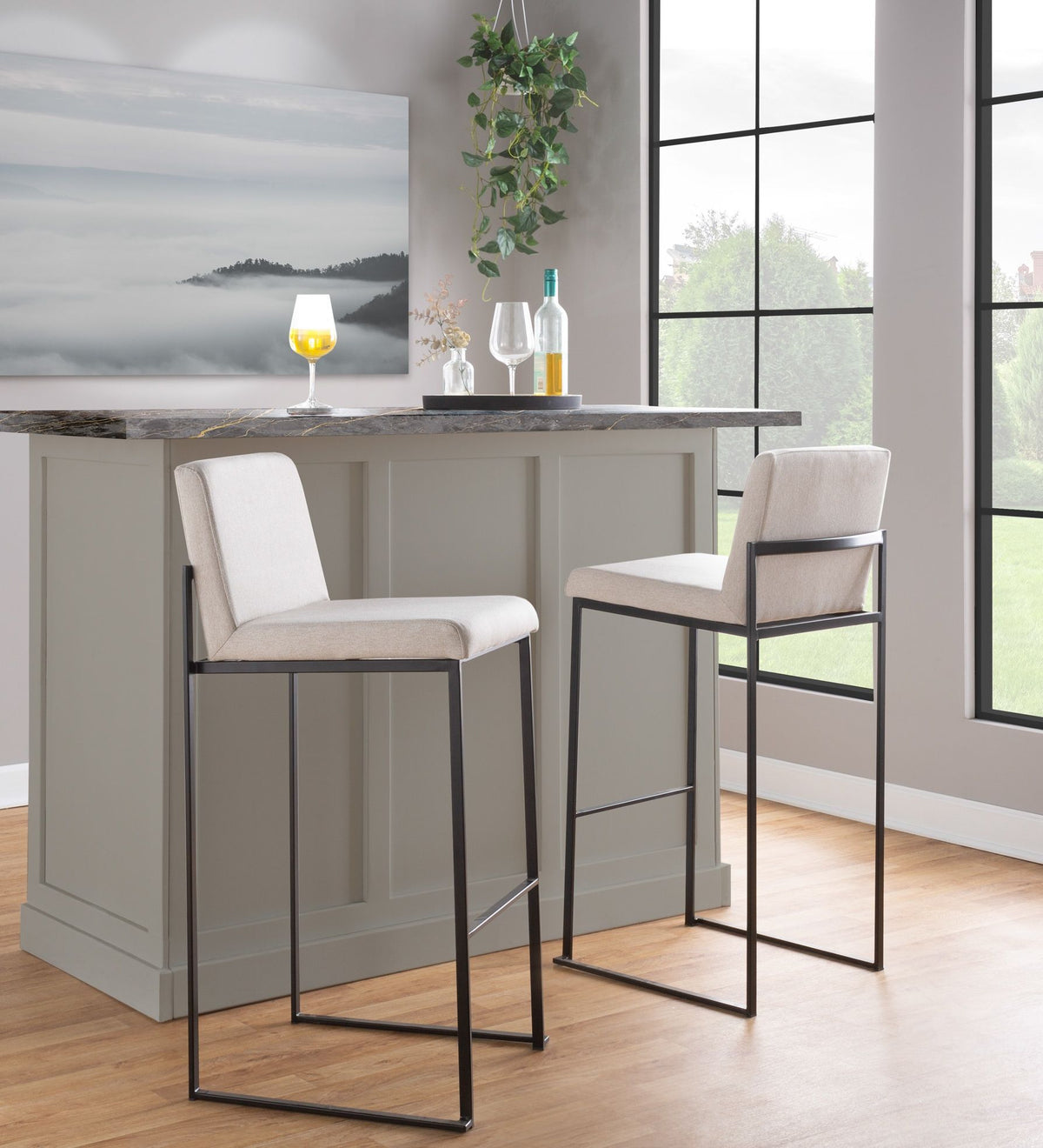 Two high back barstools with beige upholstery and black metal bases at granite island on Tampa Home & Garden Store