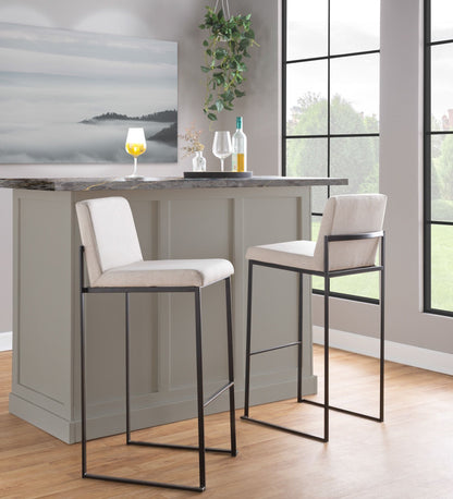 Two high back barstools with beige upholstery and black metal bases at granite island on Tampa Home & Garden Store