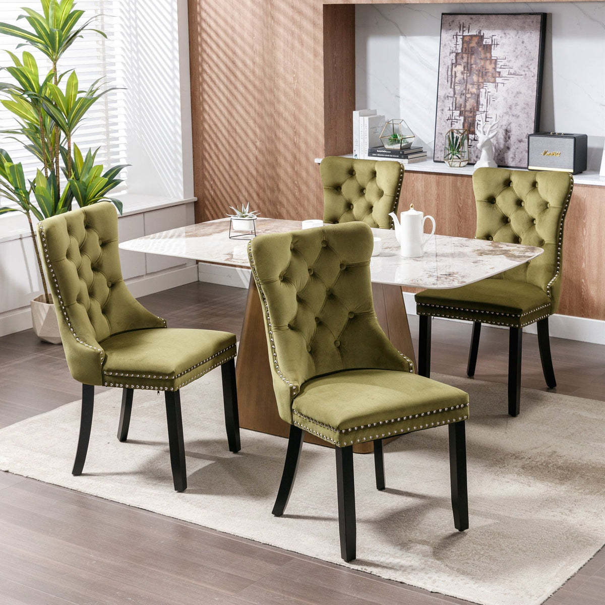 Tufted velvet dining chairs set in green with nailhead trim, 4 chairs around marble table on Tampa Home & Garden Store