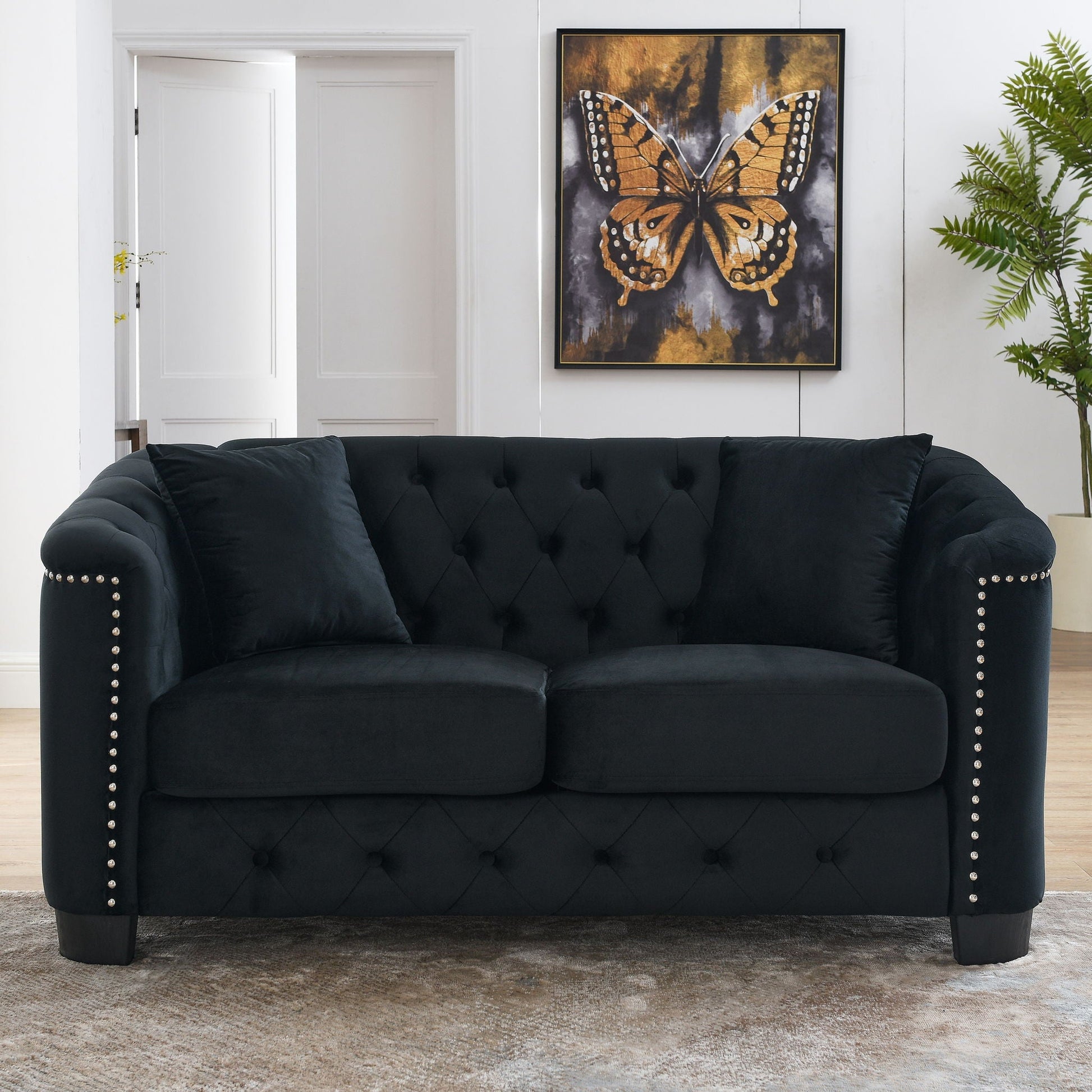 Modern Chesterfield sofa with tufted back and black velvet upholstery, nailhead trim on Tampa Home & Garden Store