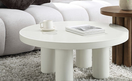 Loanna White Coffee Table round table with three cylindrical legs in a modern living room on Tampa Home & Garden Store