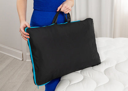 Bed Gear Performance Pillow Bag backrest pillow in black with blue edge trim, held by a person on Tampa Home & Garden Store