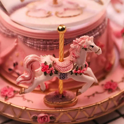 Crystal music box carousel featuring a white flowered horse, pink roses, and gold trim on Tampa Home & Garden Store