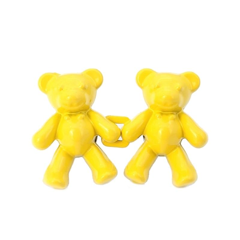 Two yellow bear-shaped plastic figurines linked together on Tampa Home & Garden Store