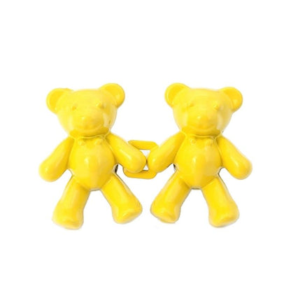 Two yellow bear-shaped plastic figurines linked together on Tampa Home & Garden Store