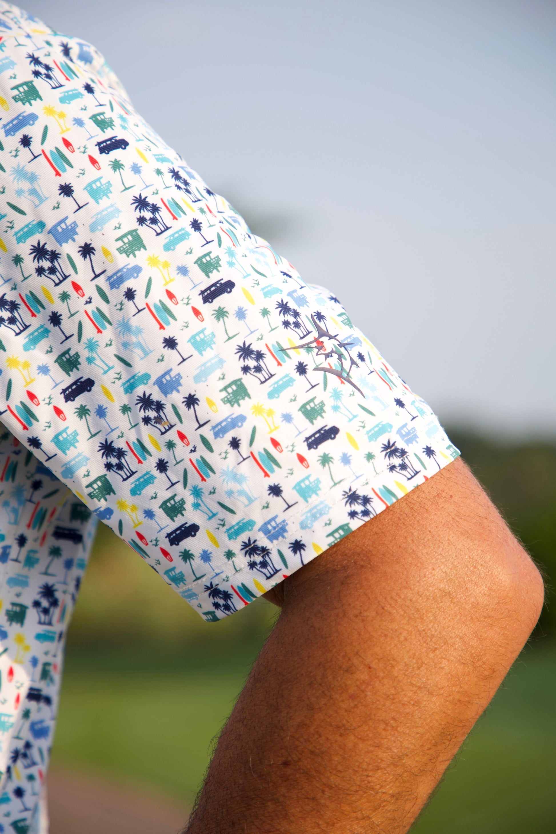 Surfs up Performance Polo by White Water Life; white polo with colorful palm tree print on Tampa Home & Garden Store