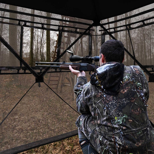 GemGear camo 2-3 person hunting blind interior with hunter aiming scoped rifle on Tampa Home & Garden Store