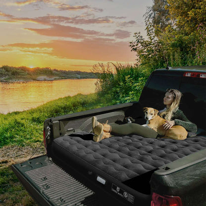 Umbrauto truck bed air mattress 5.5-6.5 ft with pump; woman and dog lounge inside truck bed on Tampa Home & Garden Store