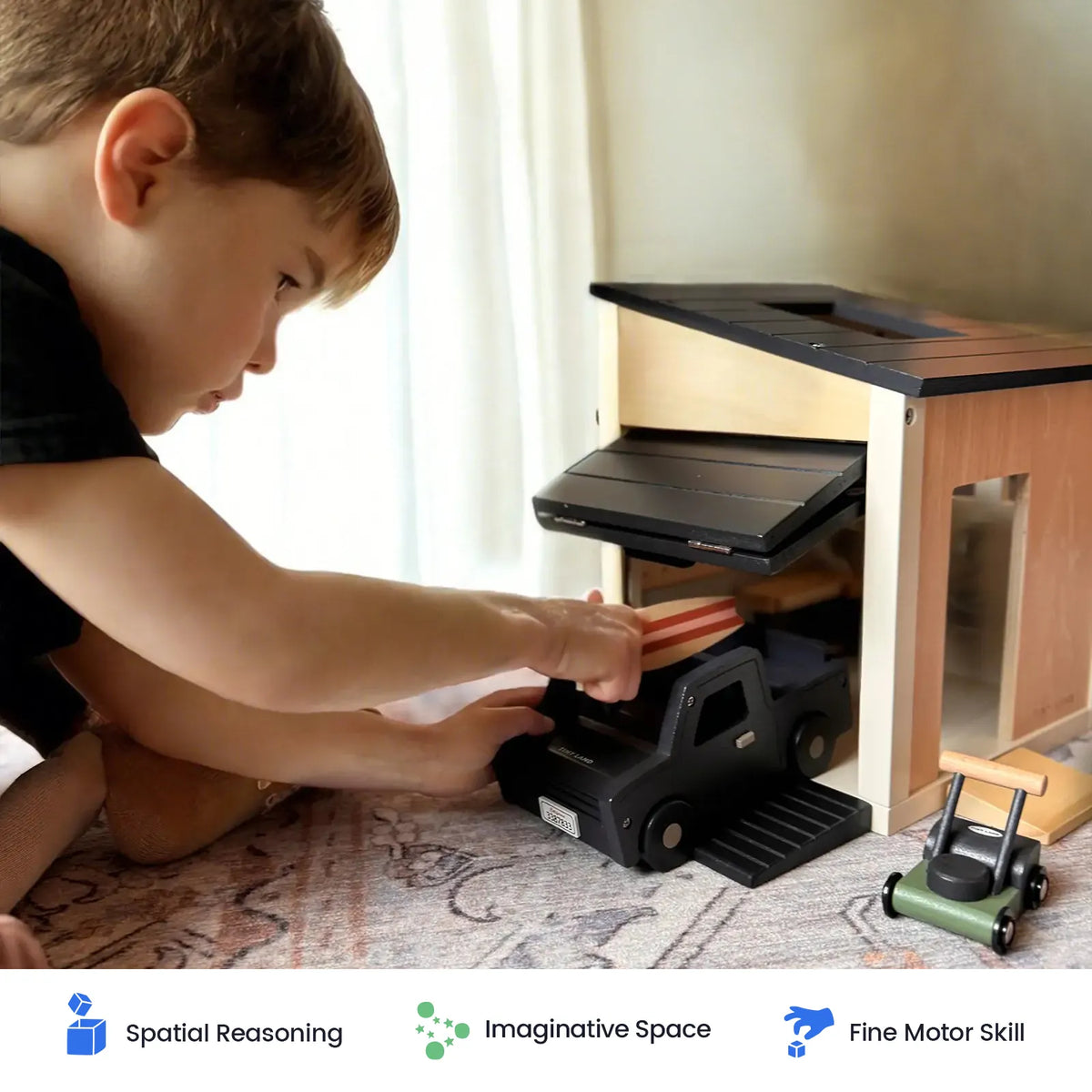 Tiny Land INC wooden dollhouse garage with black ramps; child playing at the garage opening on Tampa Home & Garden Store