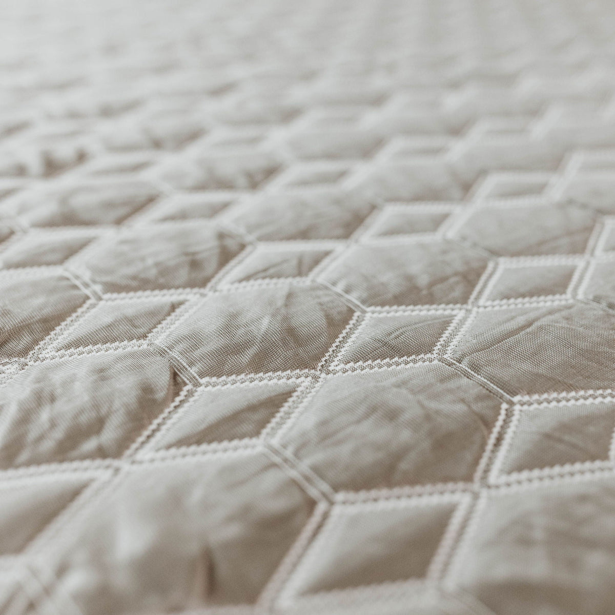 Mattress cover close-up gray plaid fabric with white stitching on Tampa Home & Garden Store