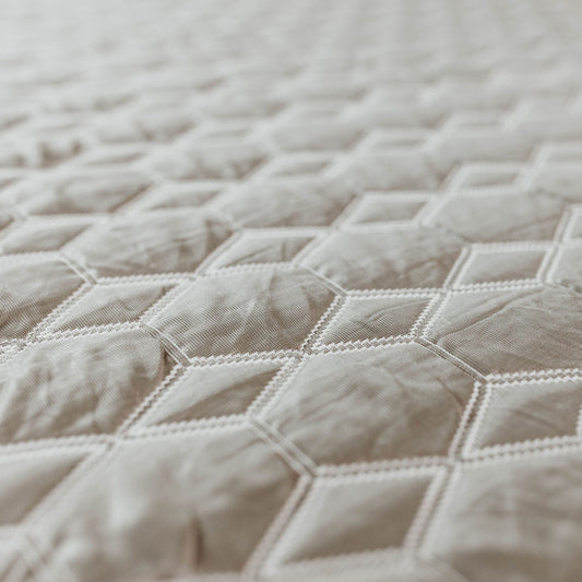 Mattress cover close-up gray plaid fabric with white stitching on Tampa Home & Garden Store