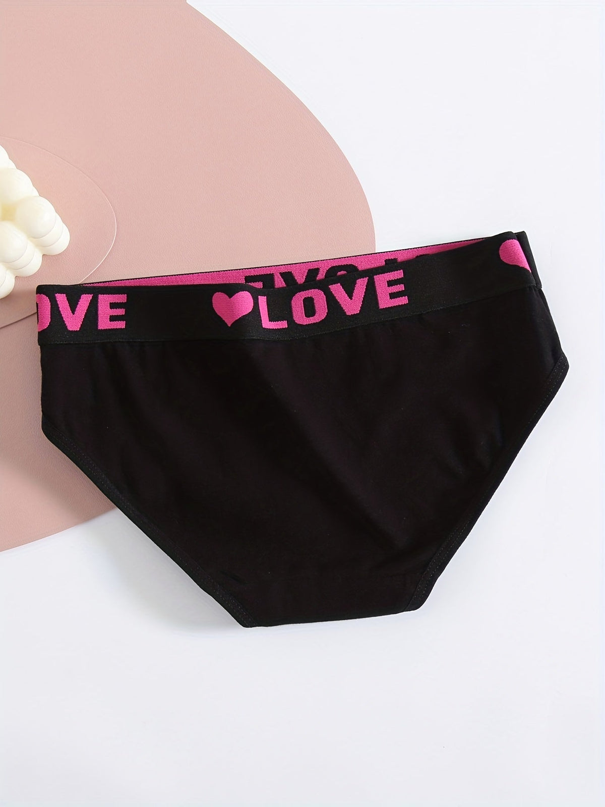 Seamless black bikini brief for women with bright pink LOVE waistband and heart motif on Tampa Home & Garden Store
