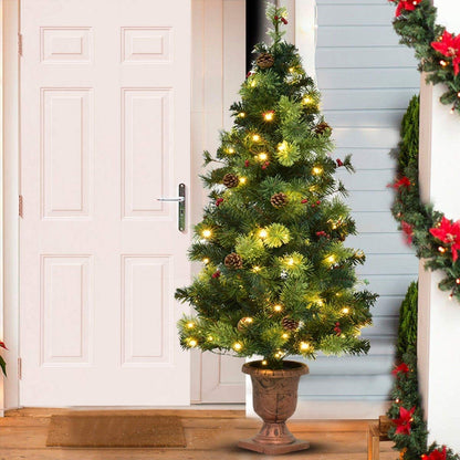 Artificial LED Christmas Tree with red berries and pine cones in a decorative urn on Tampa Home & Garden Store