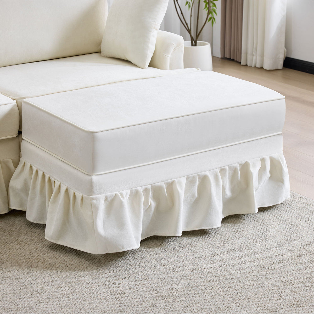 White L-shaped sectional sofa with removable ruffled skirt and ottoman, fabric upholstery on Tampa Home & Garden Store