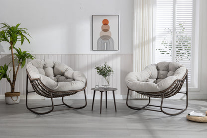 Pair of HouseOfZazla outdoor rattan rocking chairs with beige padded cushions on Tampa Home & Garden Store