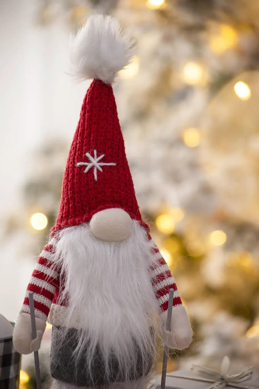 Christmas gnome decoration with red knitted hat, beard, white pom-pom, striped sleeves on Tampa Home & Garden Store