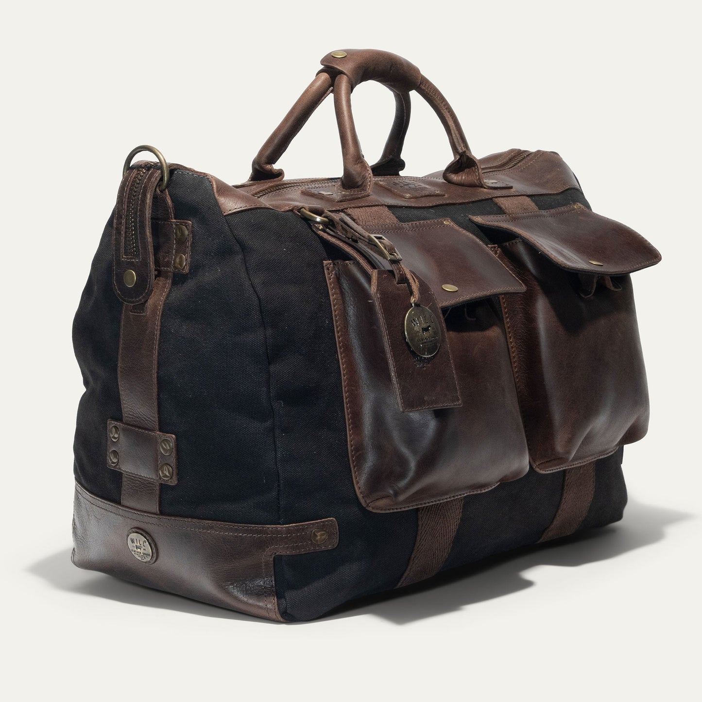 Will Leather Goods Travel Duffle in black canvas with brown leather trim and handles on Tampa Home & Garden Store