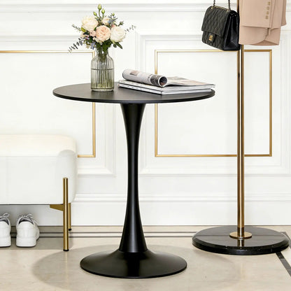 Black round dining table with tulip-style pedestal base, vase of pale roses and magazines on top on Tampa Home & Garden Store