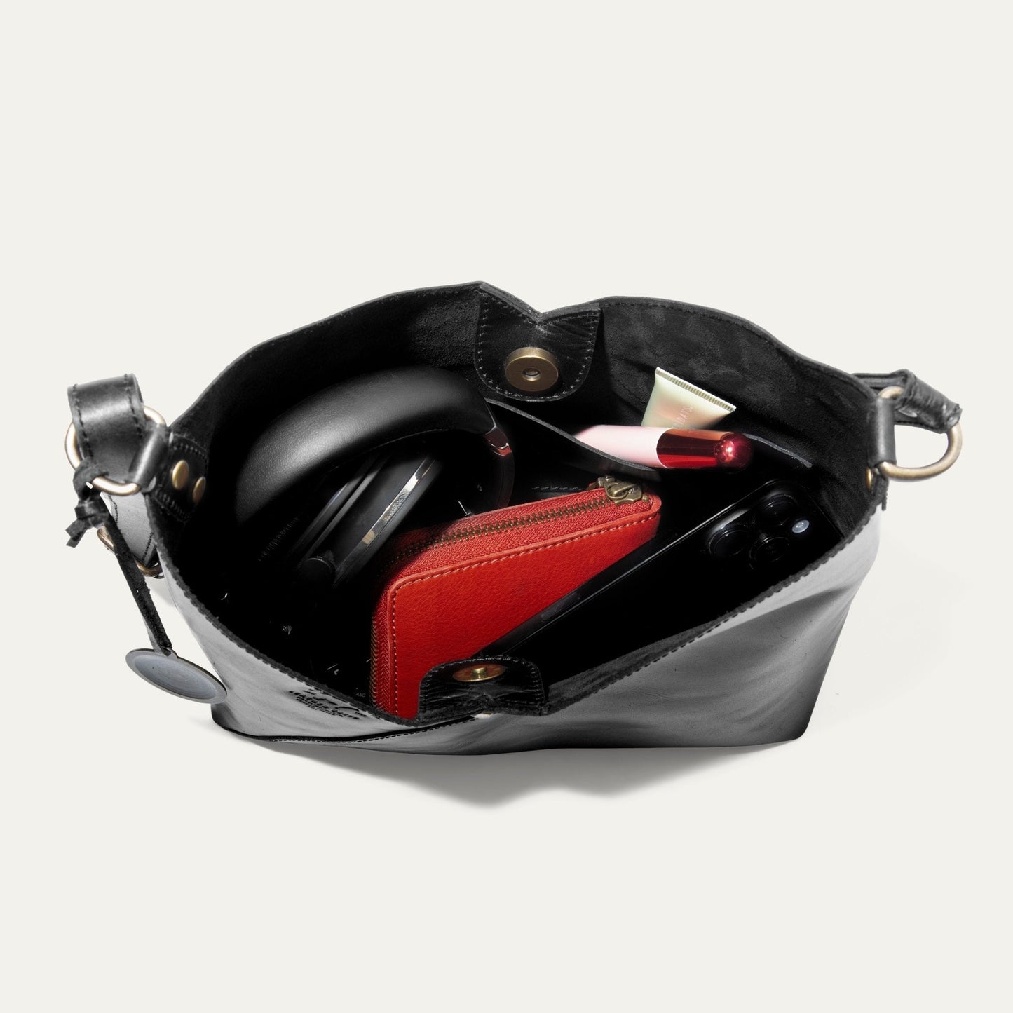 Simple Mini V Hobo bag in black leather with brass hardware and red interior zip pocket on Tampa Home & Garden Store