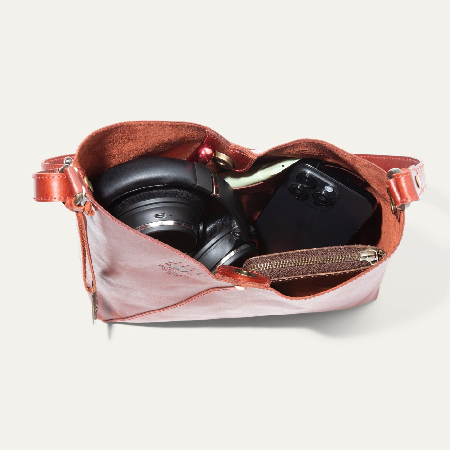 Simple Mini V Hobo bag by Will Leather Goods in red leather with black headphones inside on Tampa Home & Garden Store
