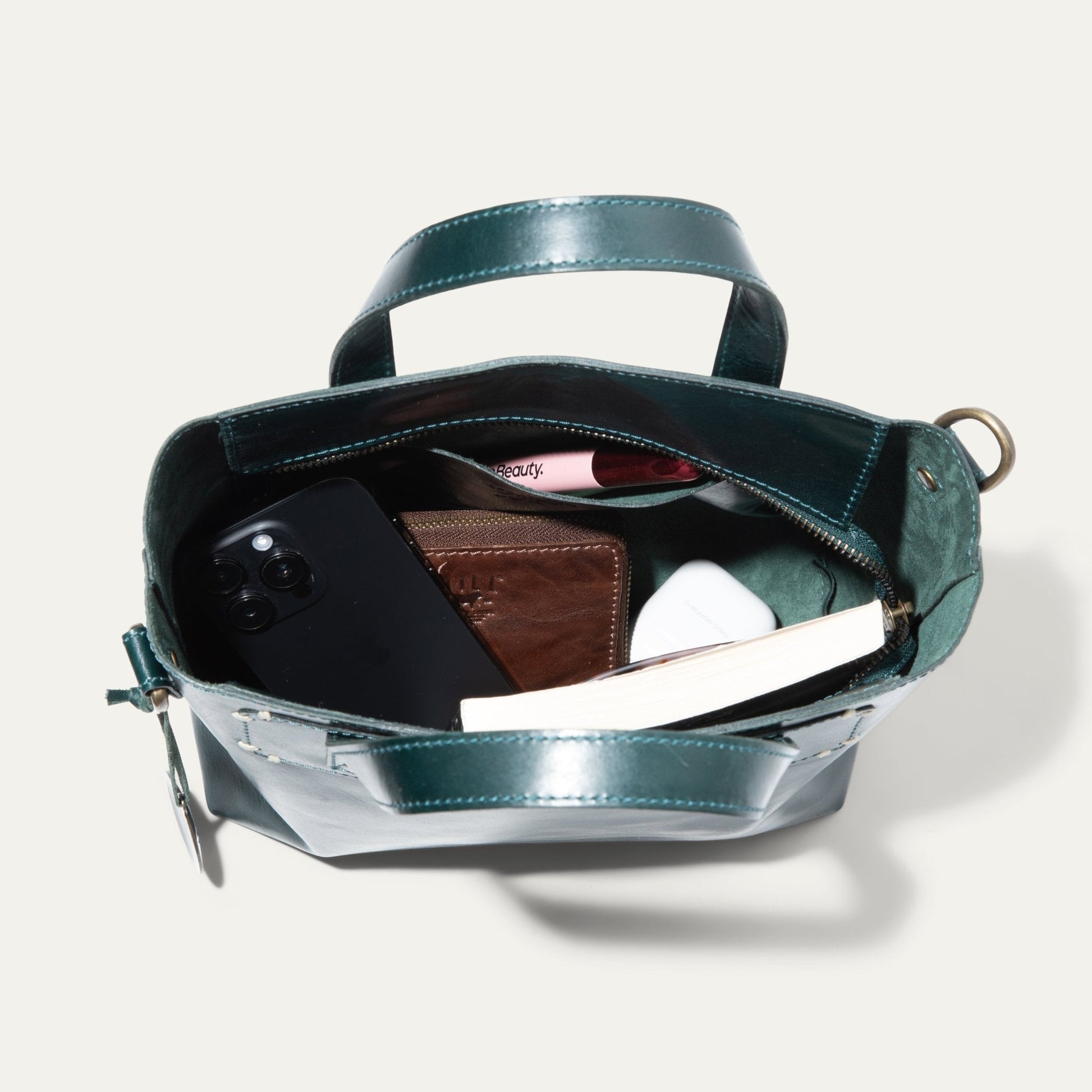 Will Leather Goods Simple Mini Satchel teal leather with top handle, open to show phone on Tampa Home & Garden Store