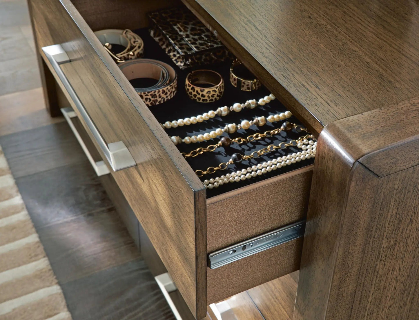 Marxmore dresser in dark wood with open top drawer showing leopard print belts and pearl jewelry on Tampa Home & Garden Store