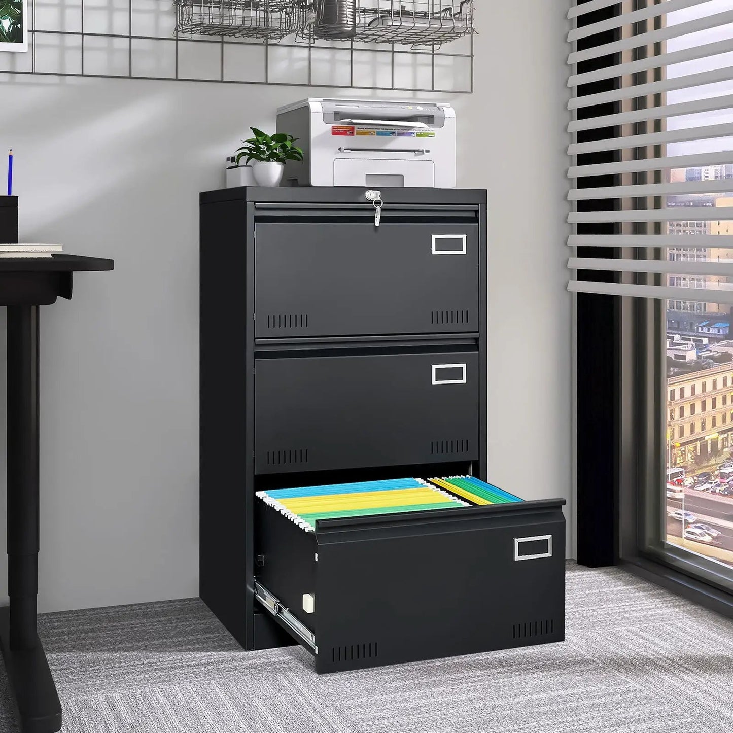 Black metal 3-drawer locking filing cabinet with bottom drawer open and color files on Tampa Home & Garden Store