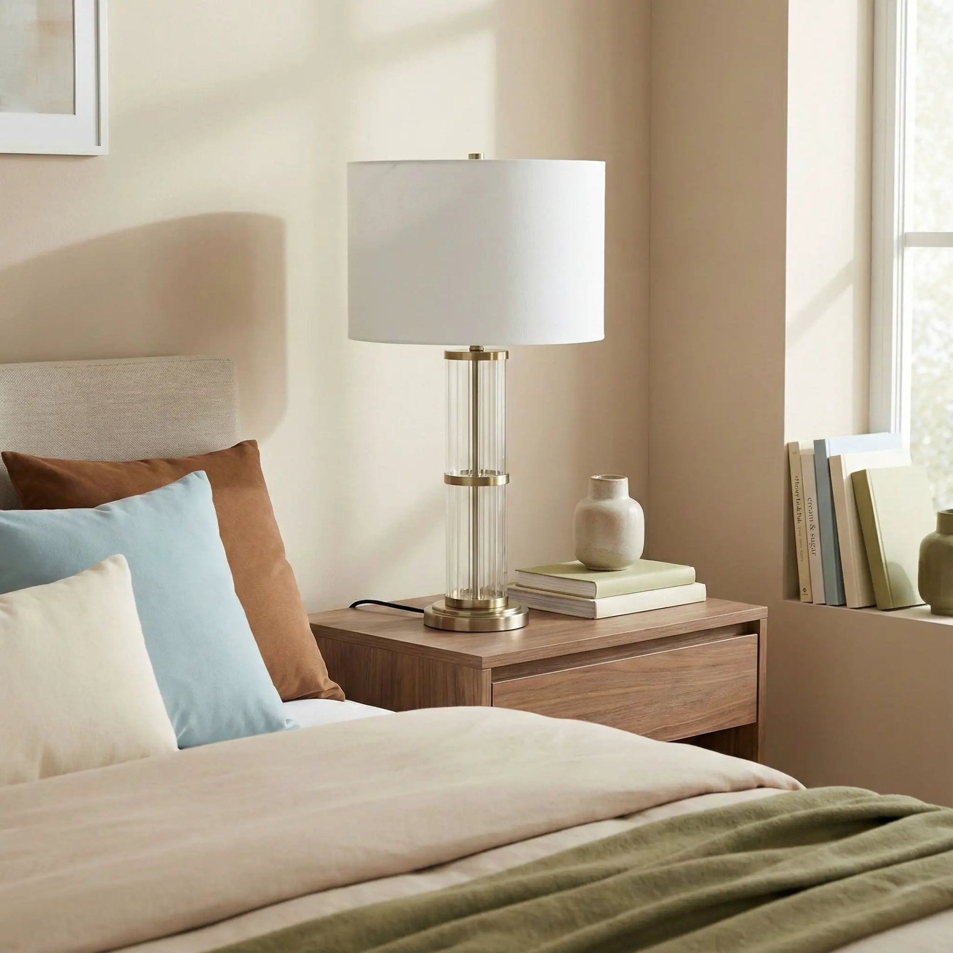 Echo table lamp with clear glass body, brass accents, and white shade on Tampa Home & Garden Store