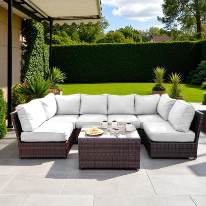 Comfortable Modern Patio Rattan Sectional with white cushions and glass-top coffee table on Tampa Home & Garden Store
